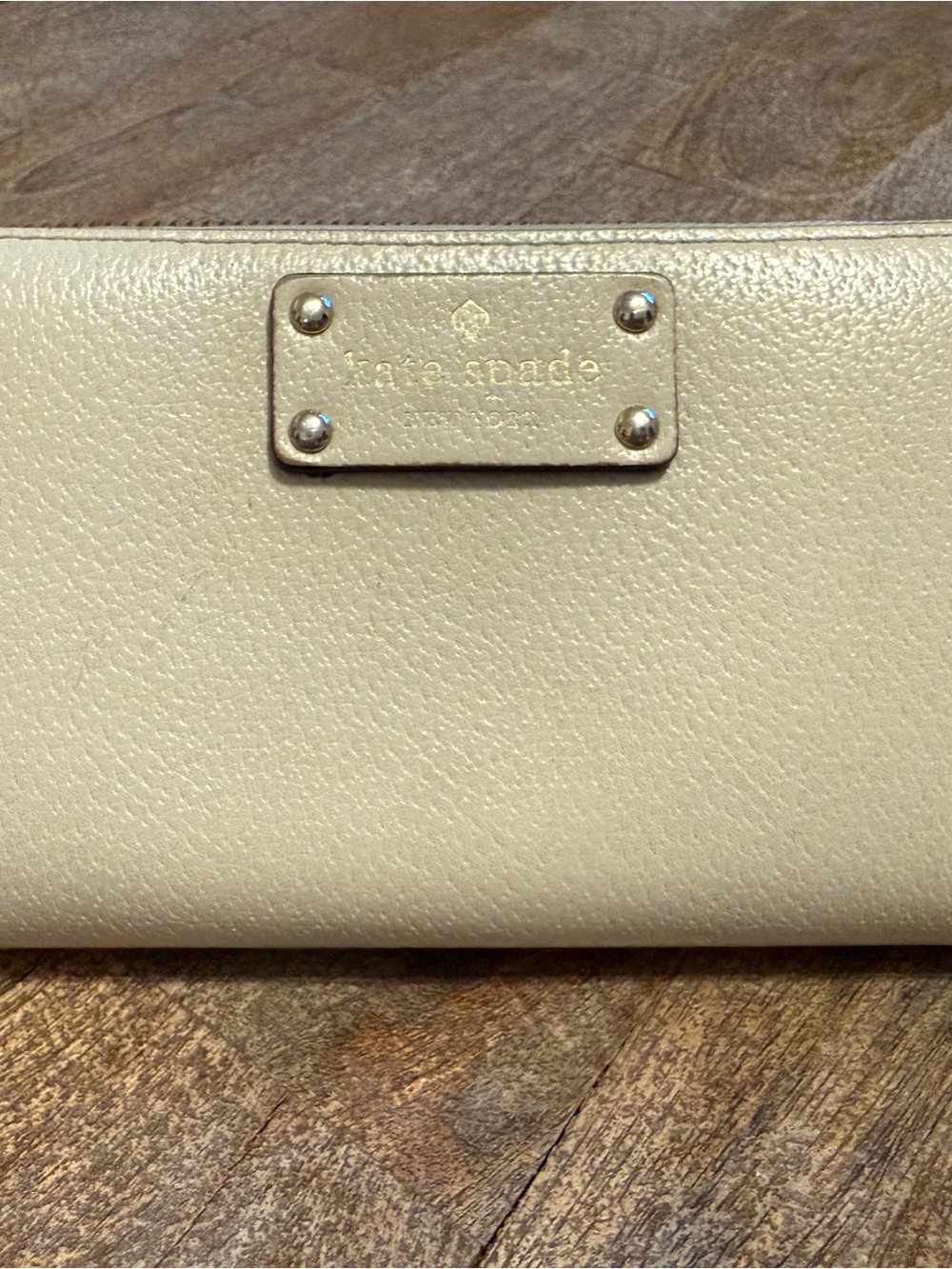 kate spade Cream Pebbled Leather Wallet with Metal Plaque